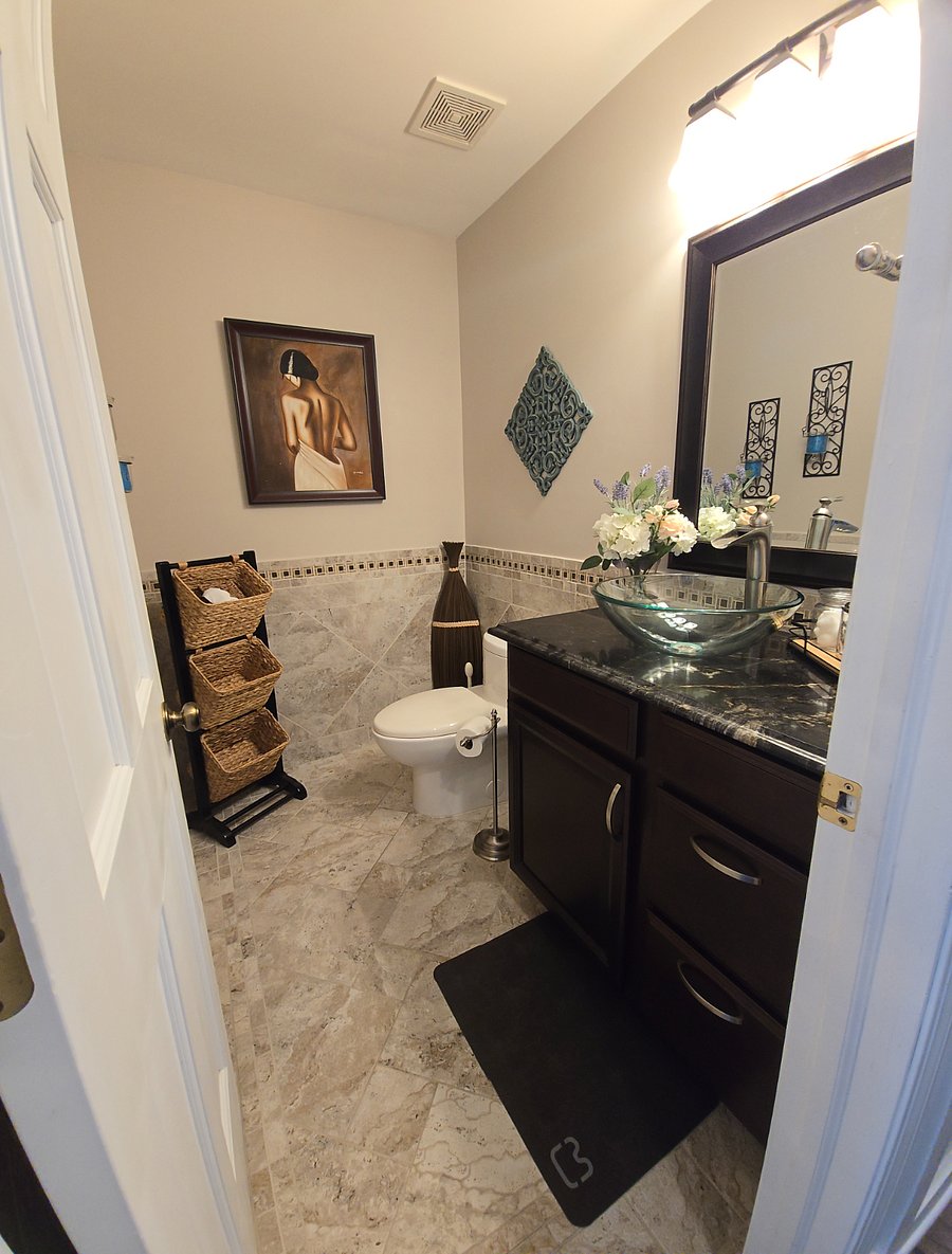 Half bath with granite countertop and vessel sink