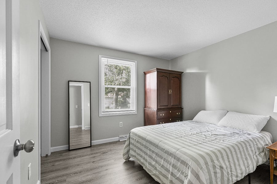 Quiet second bedroom featuring a Queen bed, dual nightstands with charging ports, and room blackout shades.