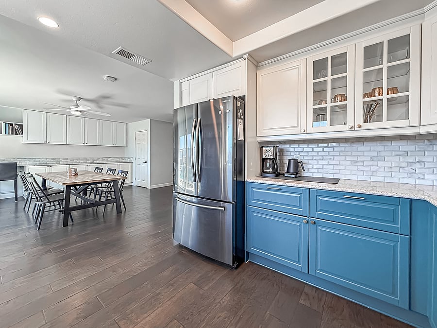 Interior Amenity - Open furnished kitchen and dining area with modern appliances, custom cabinetry, breakfast nook, and hardwood flooring flowing to the living space.