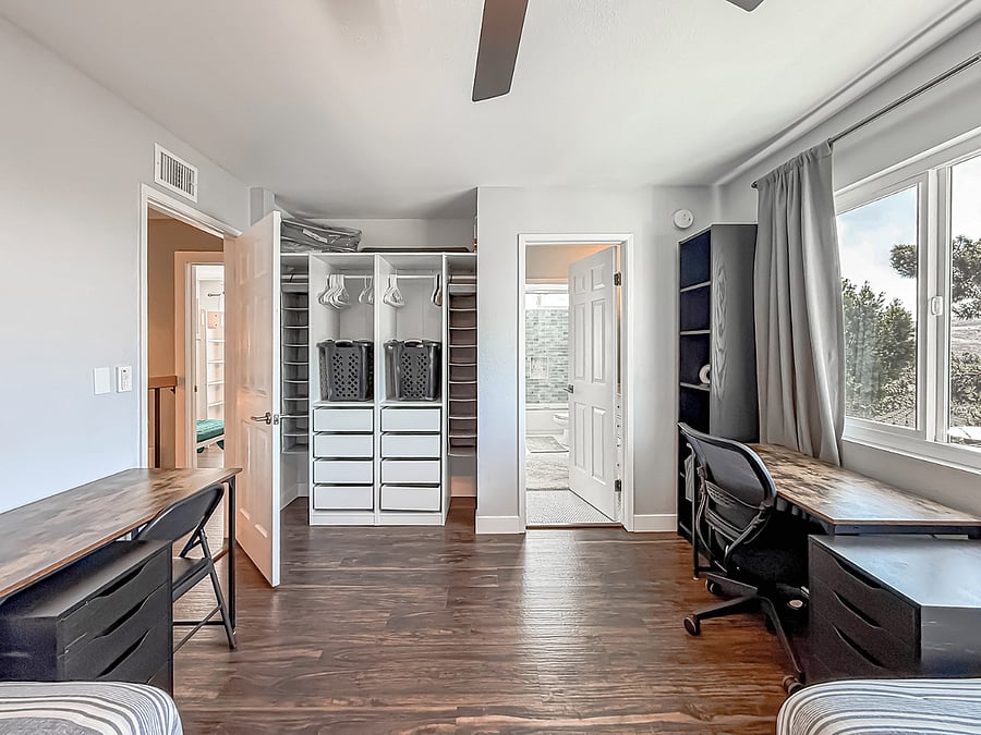 Interior - Functional furnished closet office / flex space featuring built-in dresser, organized storage, dual workstations, and large window with natural light.