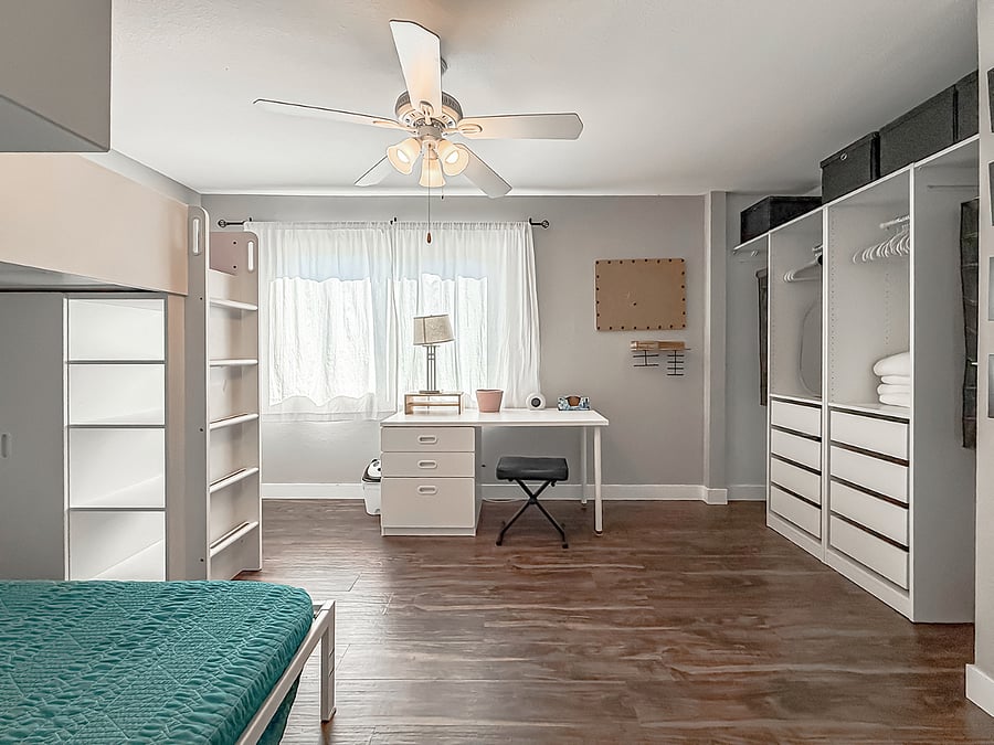 Interior - Functional furnished closet office / flex space featuring built-in dresser, organized storage, dual workstations, and large window with natural light.
