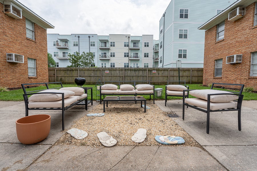 shared courtyard with outdoor seating, outdoor dining, and a BBQ grill area