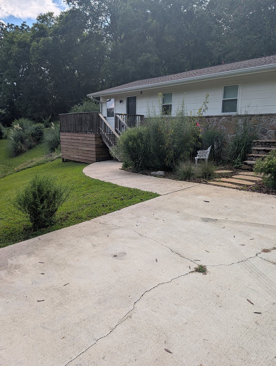 The wooden porch on the left is the studio Airbnb entrance. But there are no shared spaces or access between the studio and the main house.