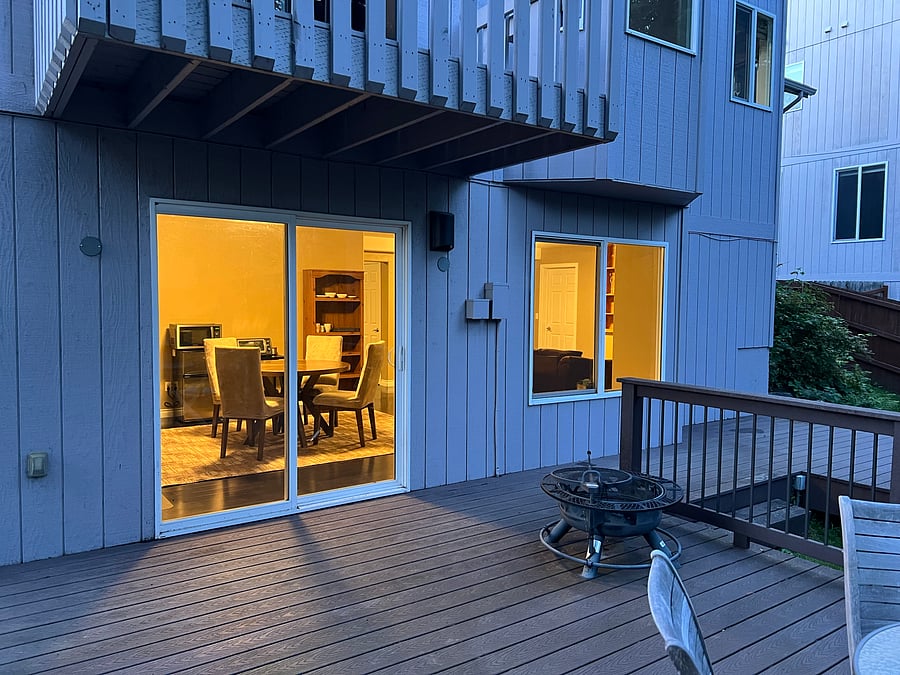 Outside: This is the view of the walk-out basement if you're standing on the back porch. The sliding door has a lock. No one lives behind us; it's just a bunch of gorgeous greenery.