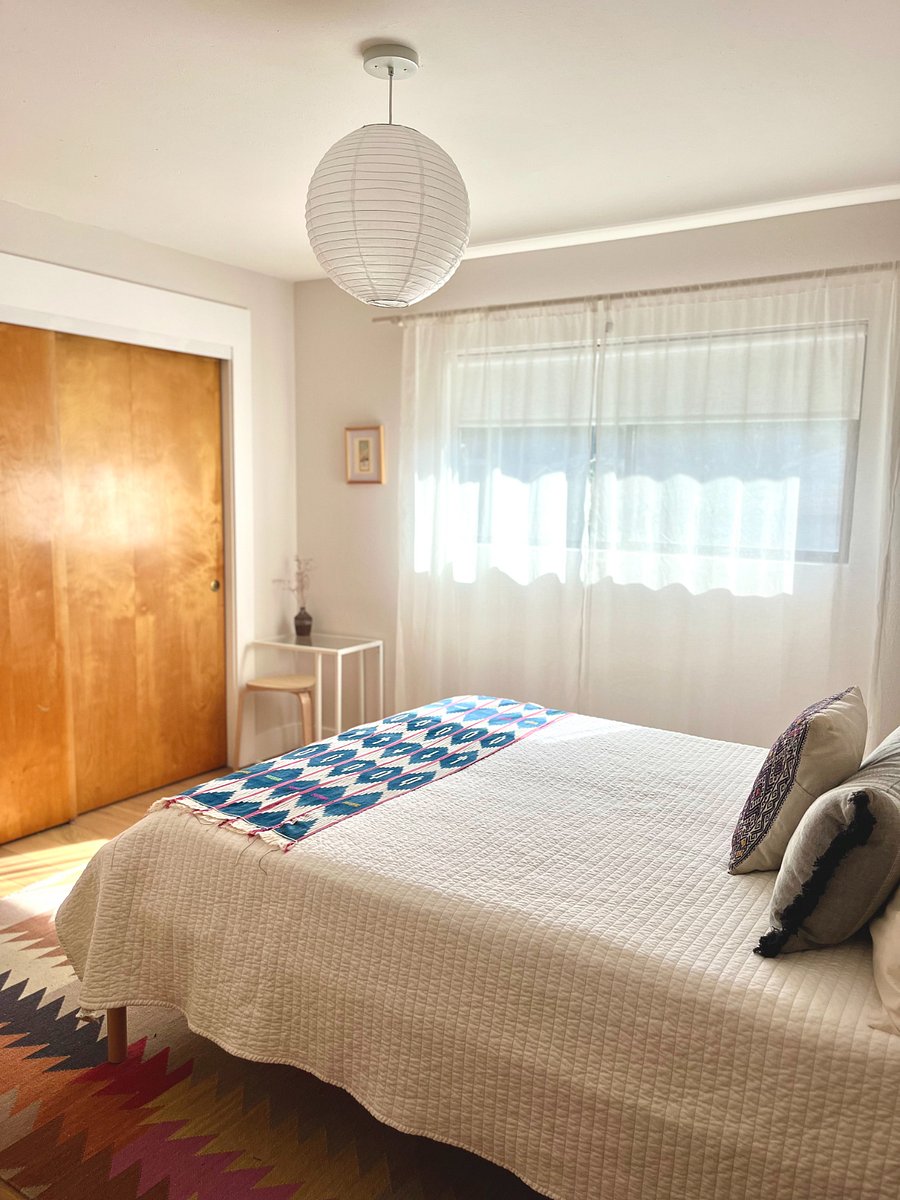 Main bedroom with queen sized bed, and blackout shades.