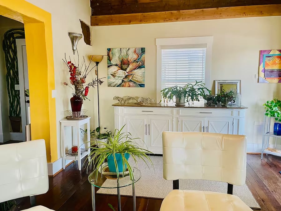 Open living room with 9' original wood ceilings and plenty of sunlight.