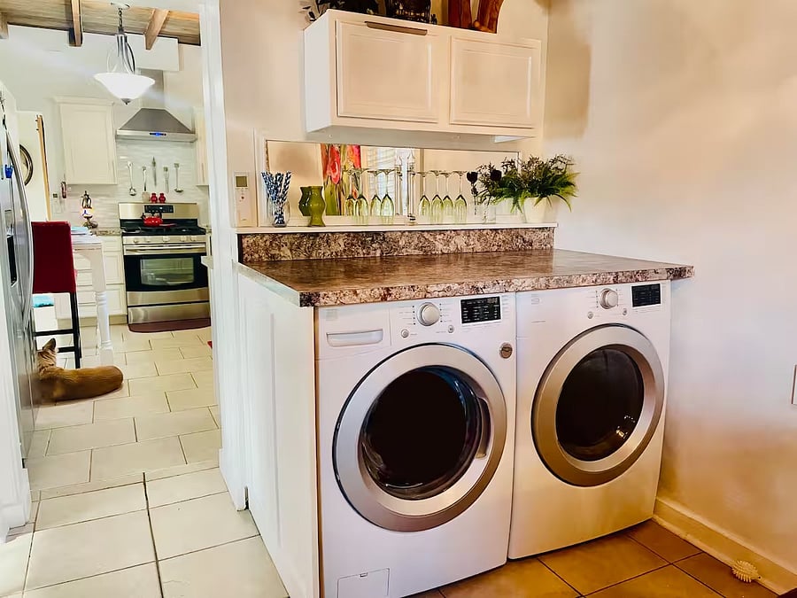 Full-sized front loader washer and electric dryer.  Initial supplies provided.