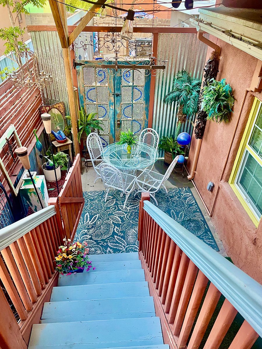 Back covered patio with dining for four and access to rooftop terrace.