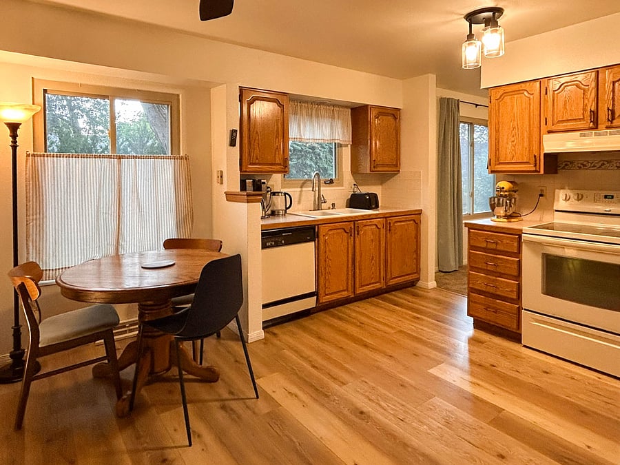 Kitchen and dining nook. Electric stove, full size refrigerator, dishwasher, kitchenaid, coffee pot, water kettle, toaster, bread machine, air fryer, and large microwave included.