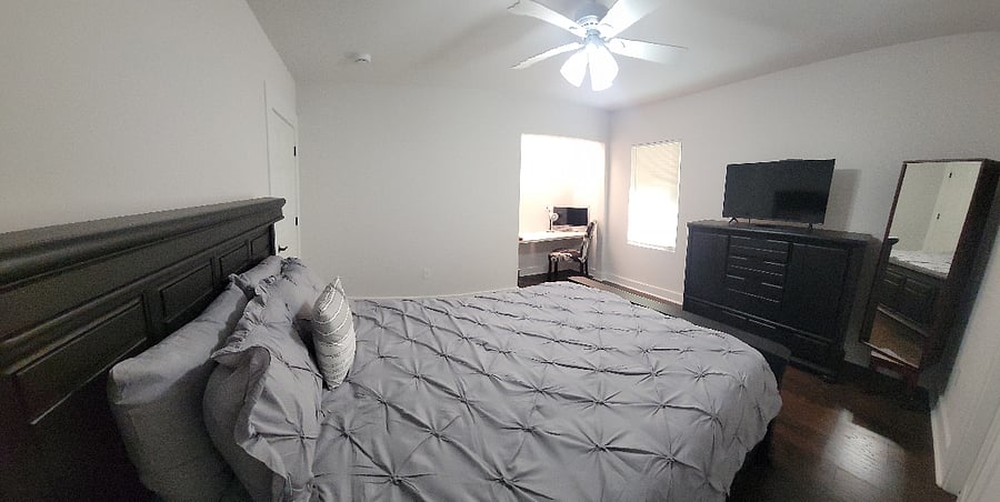 Primary bedroom with queen bed and study niche