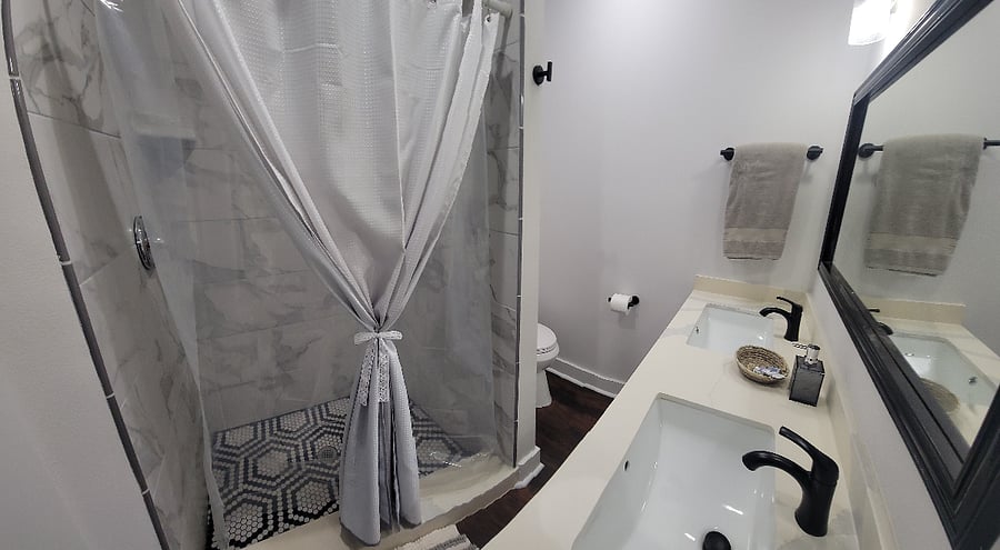 Primary bathroom with double vanity and shower