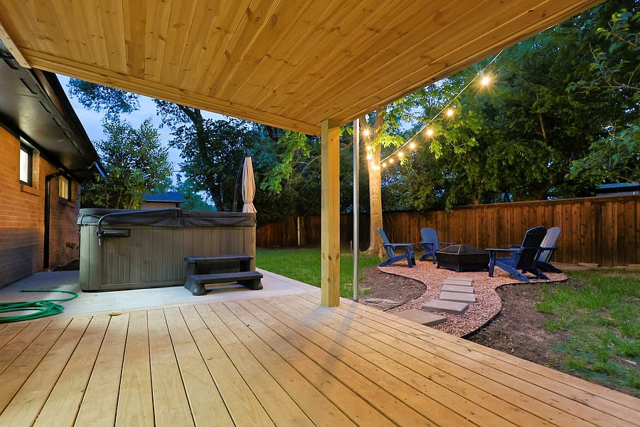 Backyard with large hot tub, fit pit and bistro lights