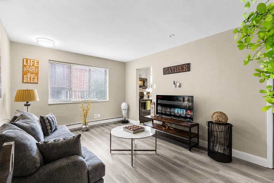 Living room sectional, smart TV, and space to unwind after a shift