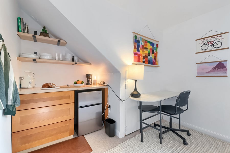 office space + private beverage and food-prep area includes a mini refrigerator, coffee maker, electric kettle, countertop and food storage. Tenant also has access to the home's shared full kitchen upstairs, including stove, oven, microwave and dishwasher.