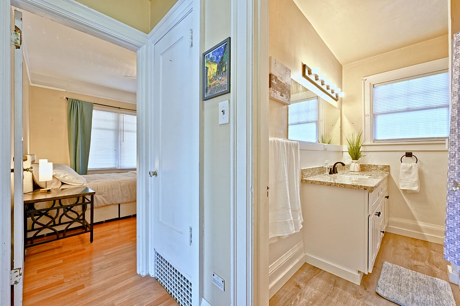 Main bedroom with hall closet door and bathroom