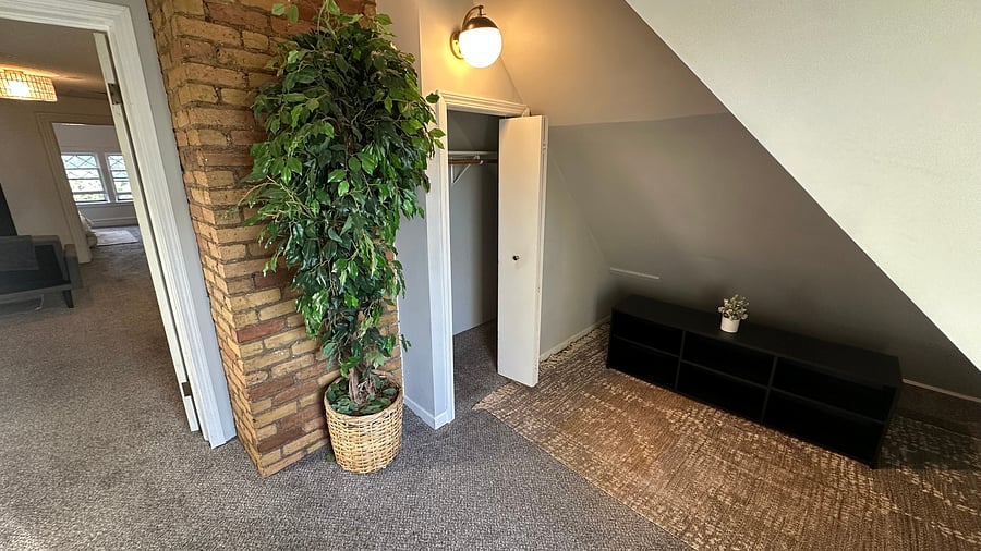 Entry with exposed brick chimney and coat closet