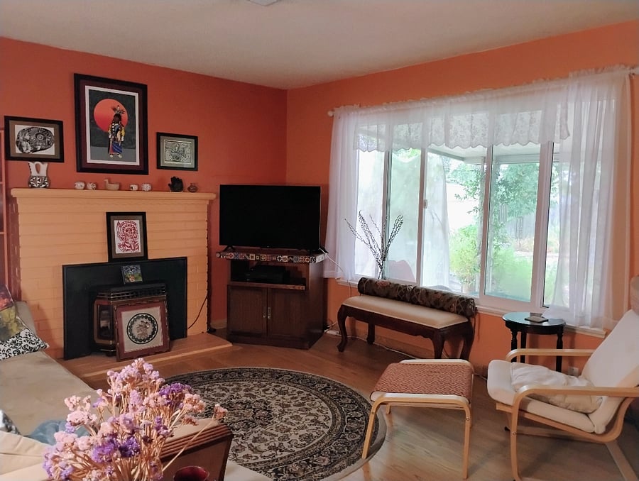 Living room with Smart TV and backyard viewing window.