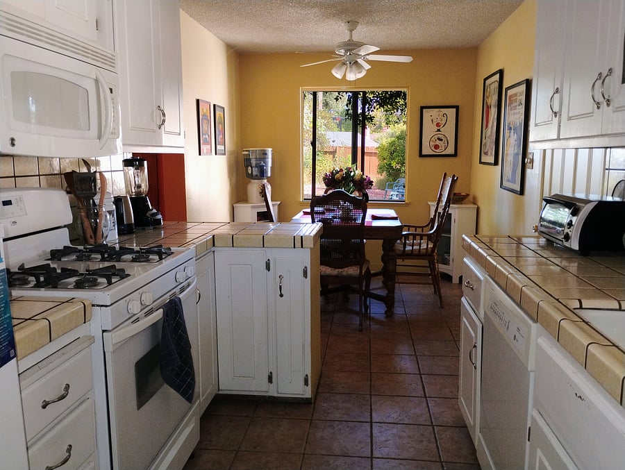 Fully equipped kitchen looking into the dining area.