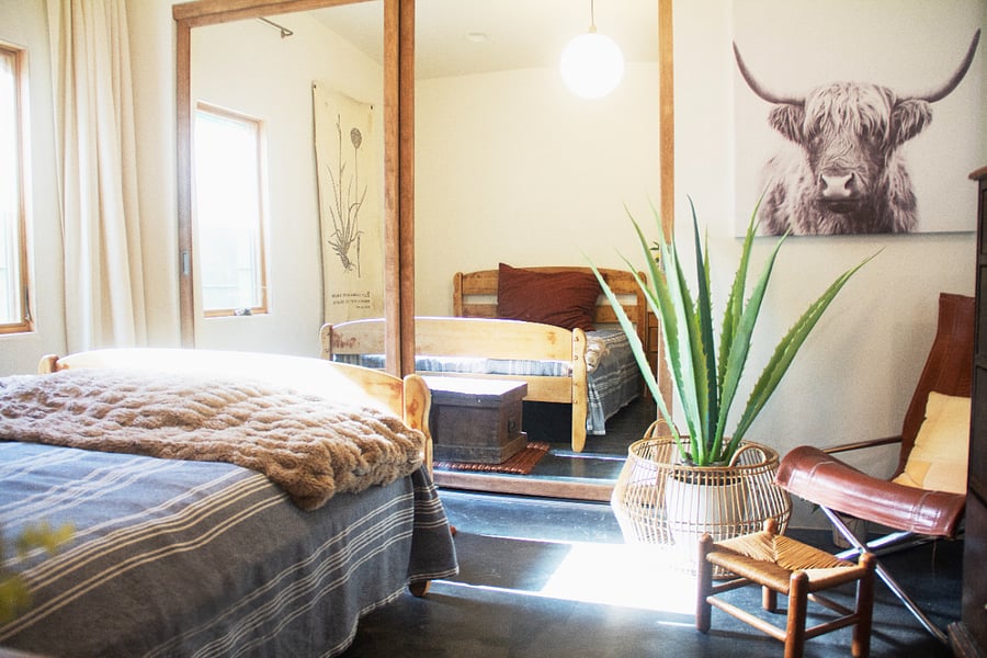 SUNLIT BEDROOM WITH FULL-SIZE BED AND READING CHAIR