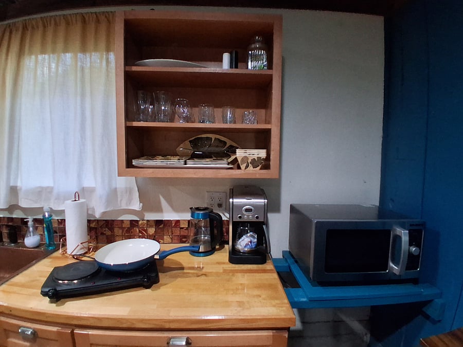 Electric burner, commercial microwave, glassware, plateware, silverware and basic cooking tools included.