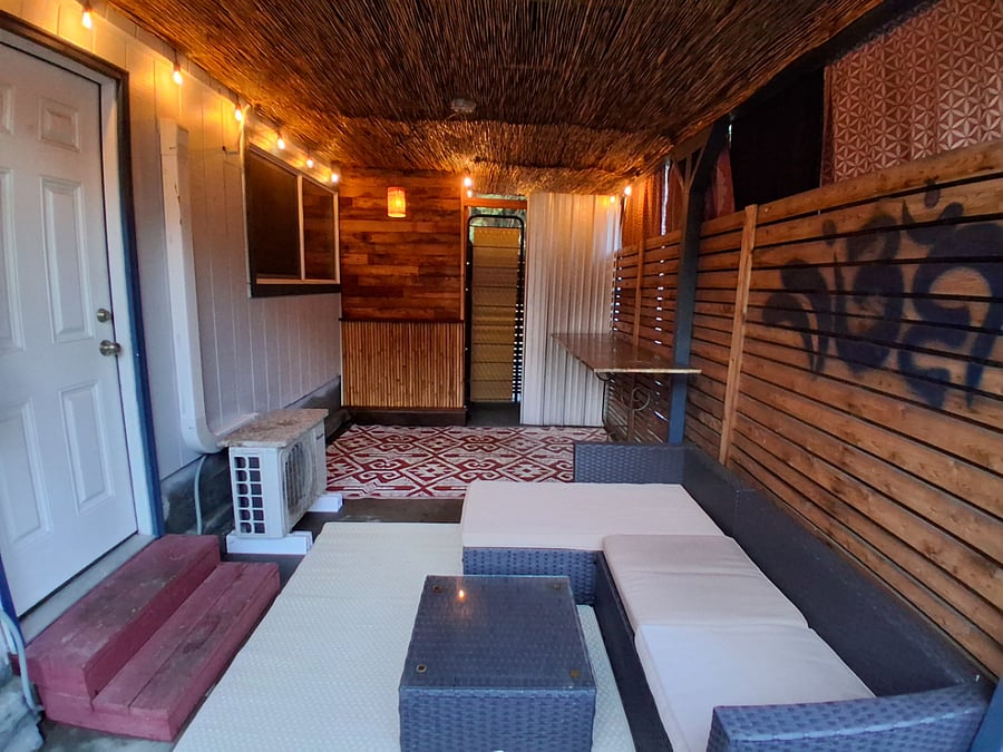 Private patio leads to the bathroom in the back... the honey-bucket and heated outdoor shower are tucked behind the dividers for privacy.