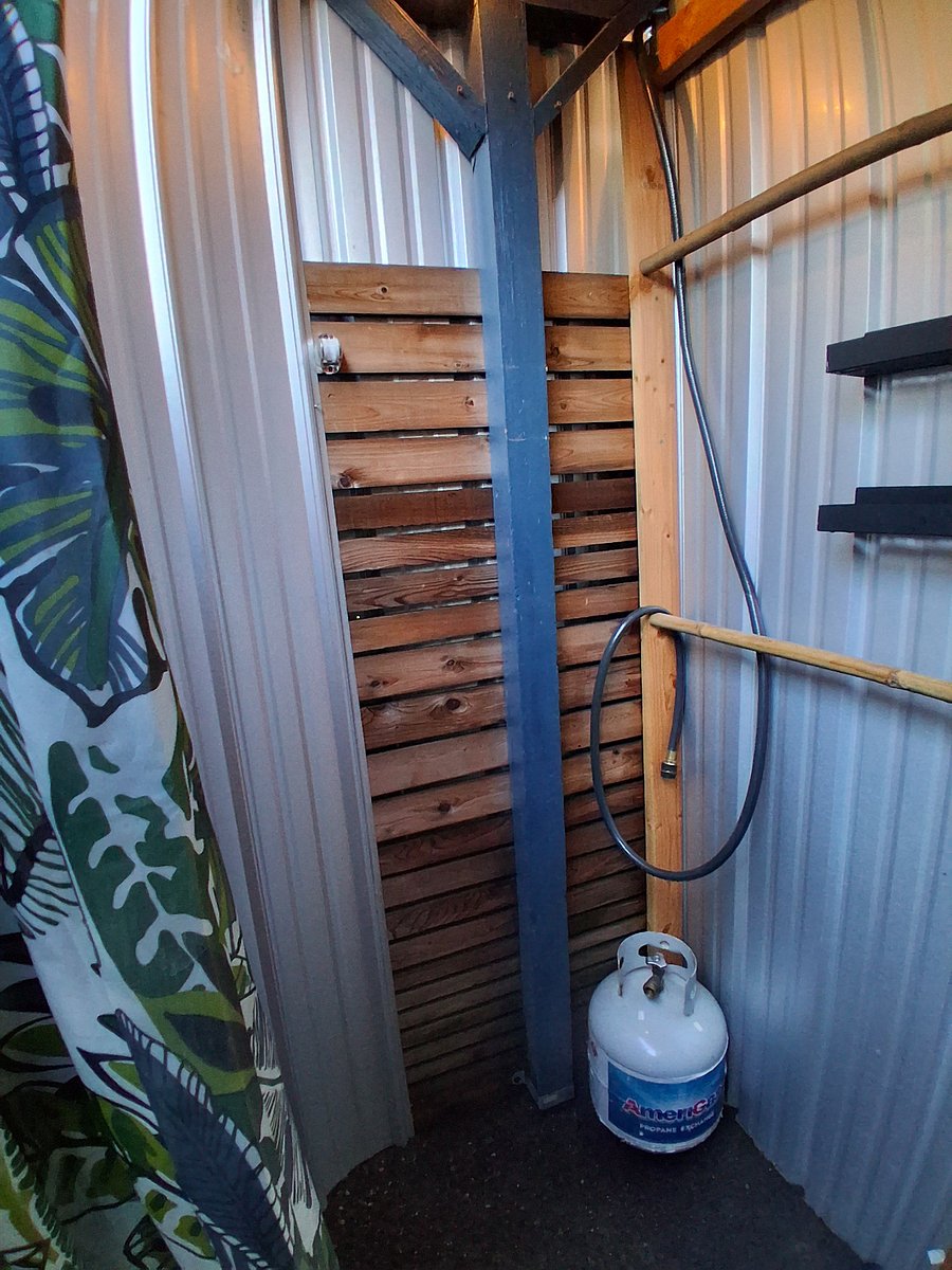 Shower area includes propane water heater and full tank upon arrival. Towels in room.
