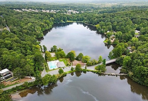 Aerial view of lakes, forest, pool. Hiking trails and wildlife included.