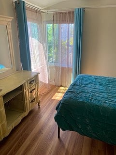 Bedroom 1. Thick windows, darkening shades, lace curtains, and blackout curtains. Windows can be kept open nearly year round, as the weather is so nice.