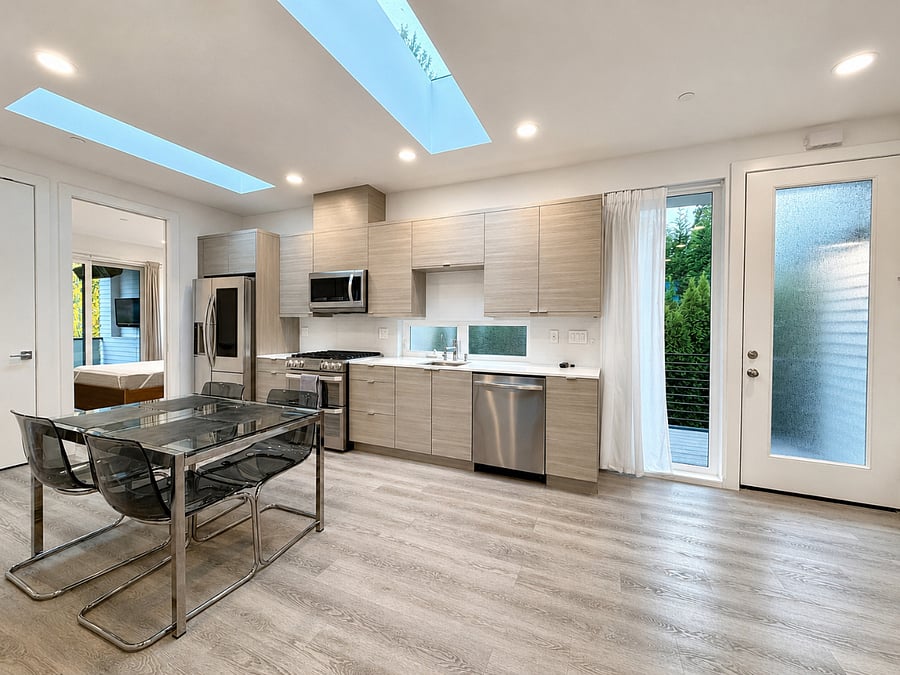 Dining and kitchen layout with skylights and abundant natural light