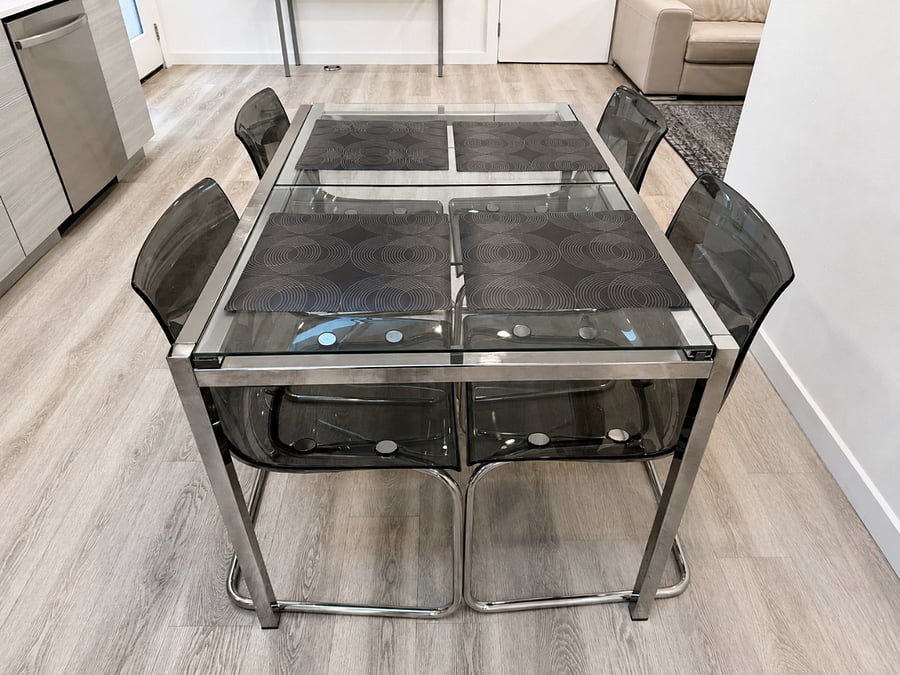 Glass dining table with seating for four - extendable to seat six