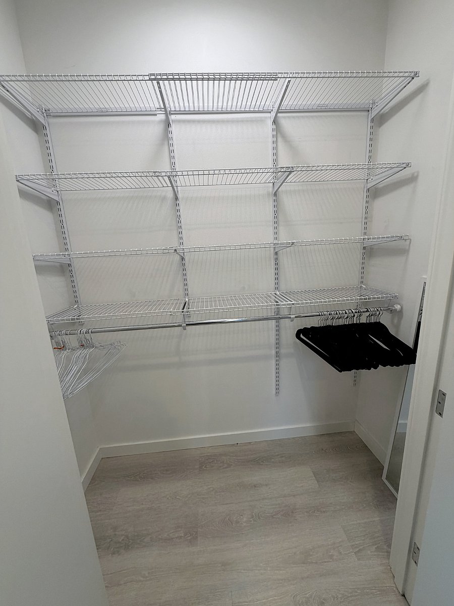 Walk in closet with extensive adjustable shelving and hanging space