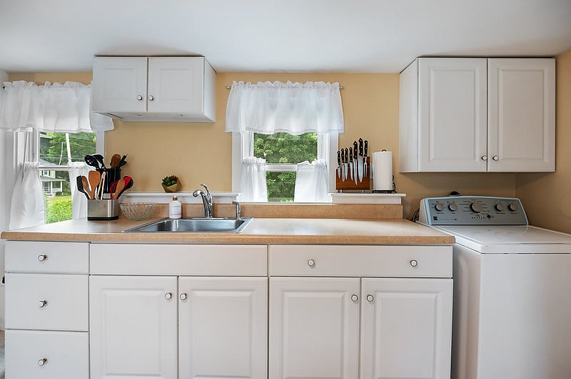 The bright kitchen is fully equipped for your cooking needs.