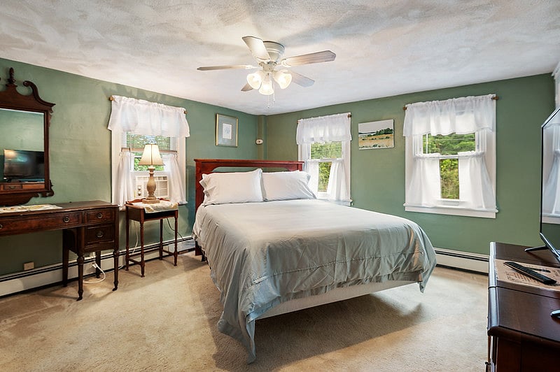 The first bedroom features a plush queen-size bed and a TV with a Fire TV Stick for streaming.