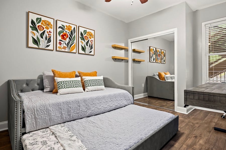 Twin trundle bedroom with closet and workspace with desk/chair.