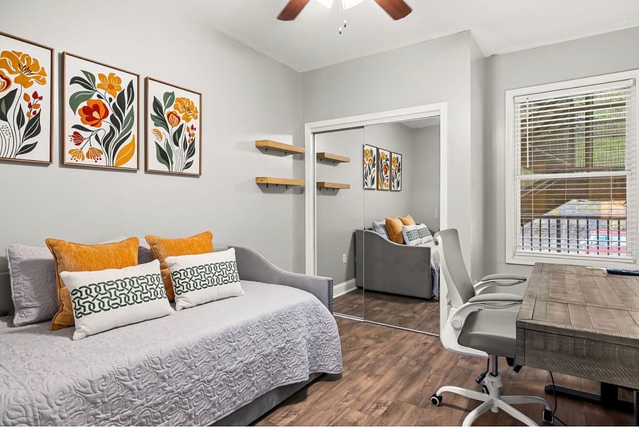 Twin trundle bedroom with closet and workspace with desk/chair.