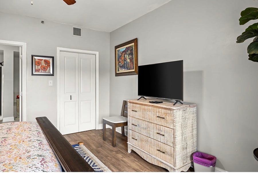 Master bedroom with walk in closet and dresser