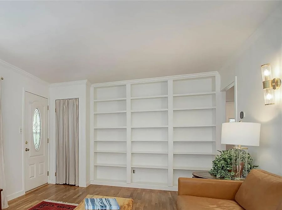 Living room with built in closet & shelves