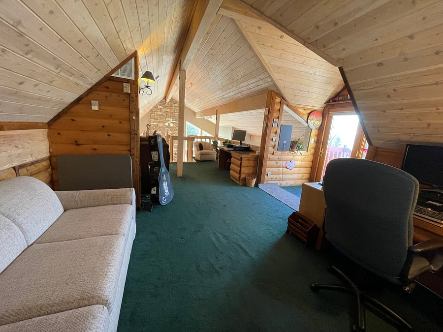 loft with pullout couch, sitting area, and 2 work stations 