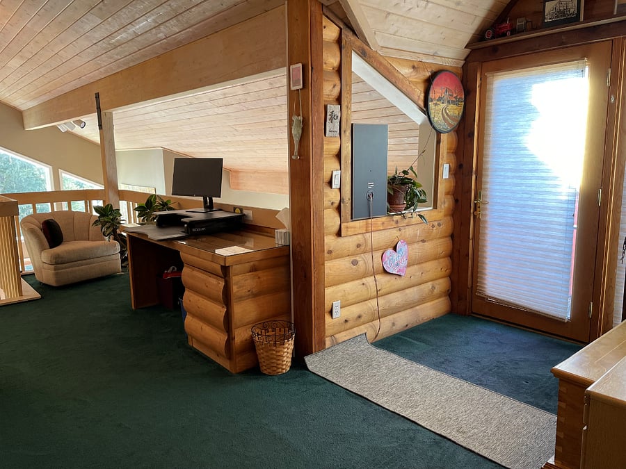 loft with pullout couch, sitting area, and 2 work stations 