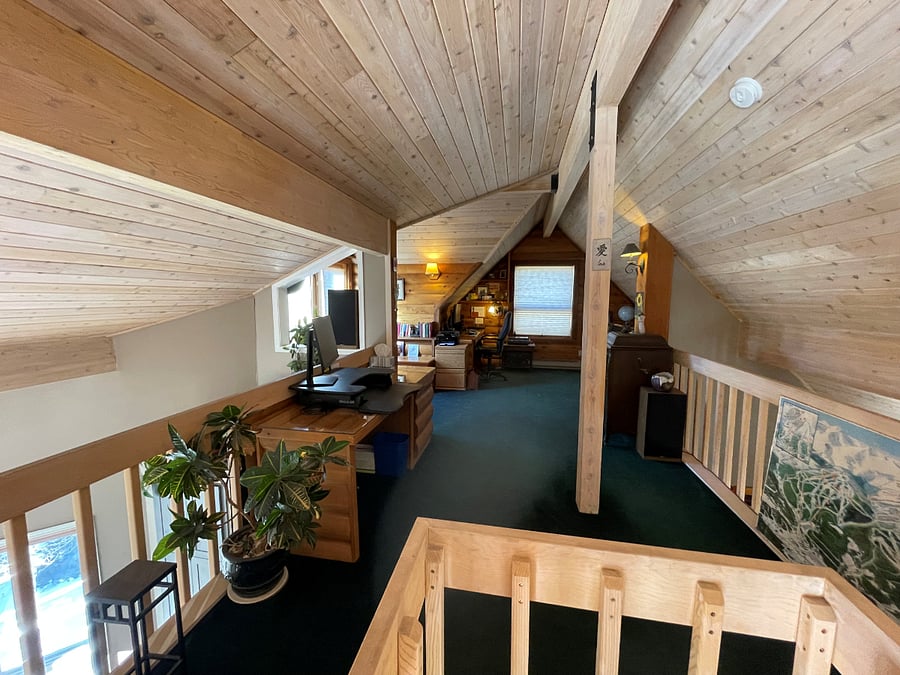 loft with pullout couch, sitting area, and 2 work stations 