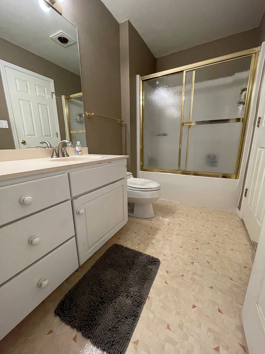 wuite bathroom with tub