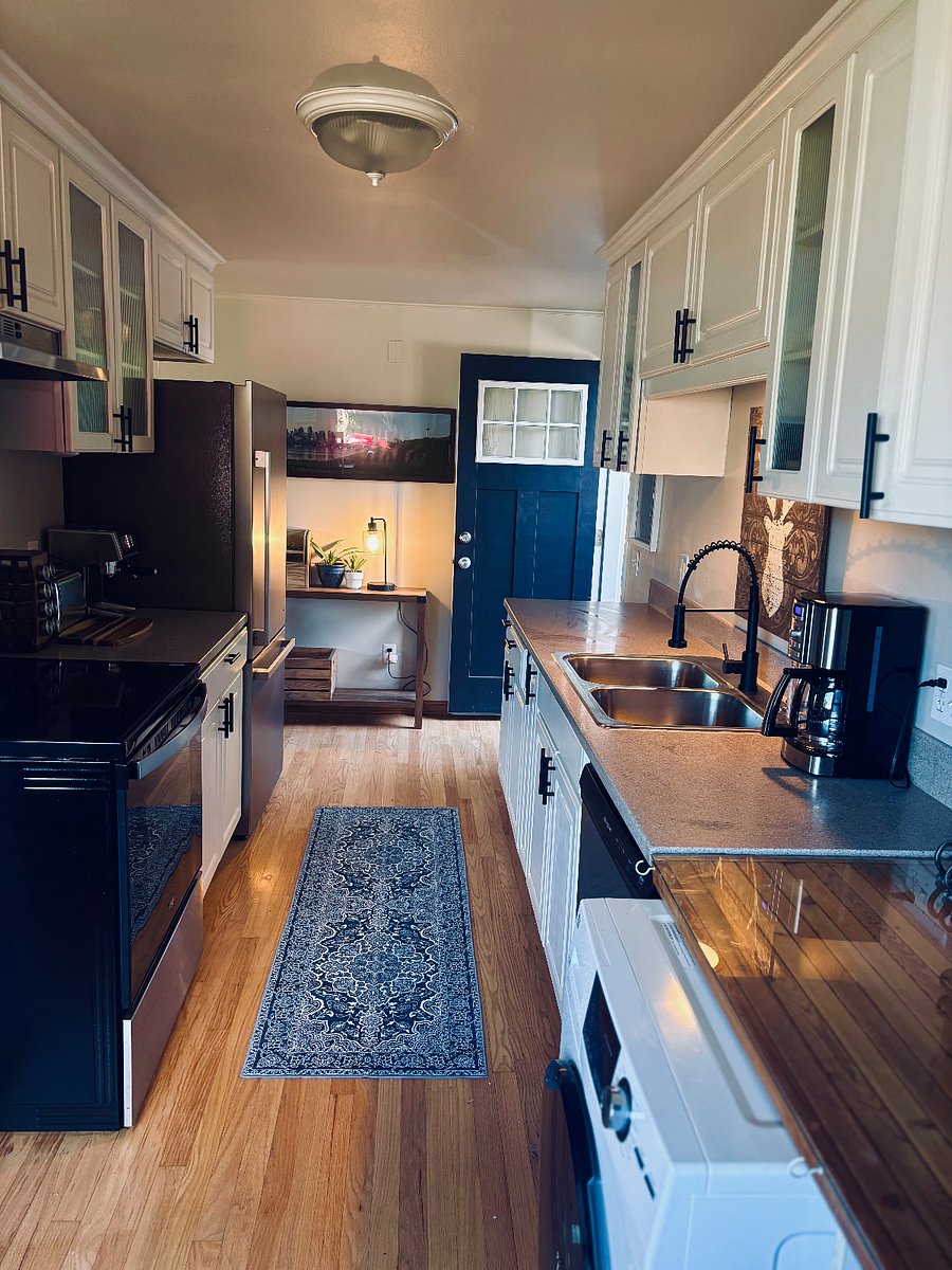 The back door is off the kitchen and has a table for keys, charging etc
