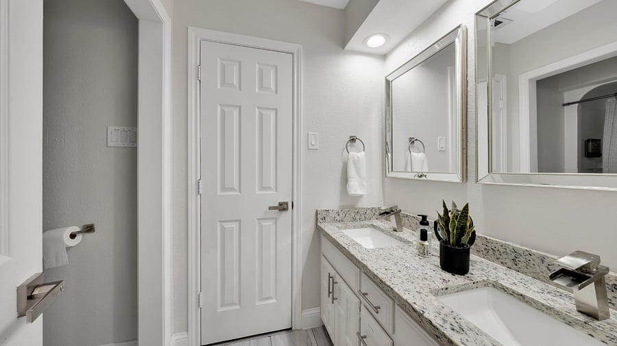 Jack-and-Jill Bathroom: Convenient shared bathroom with a tub and shower combination between two bedrooms.