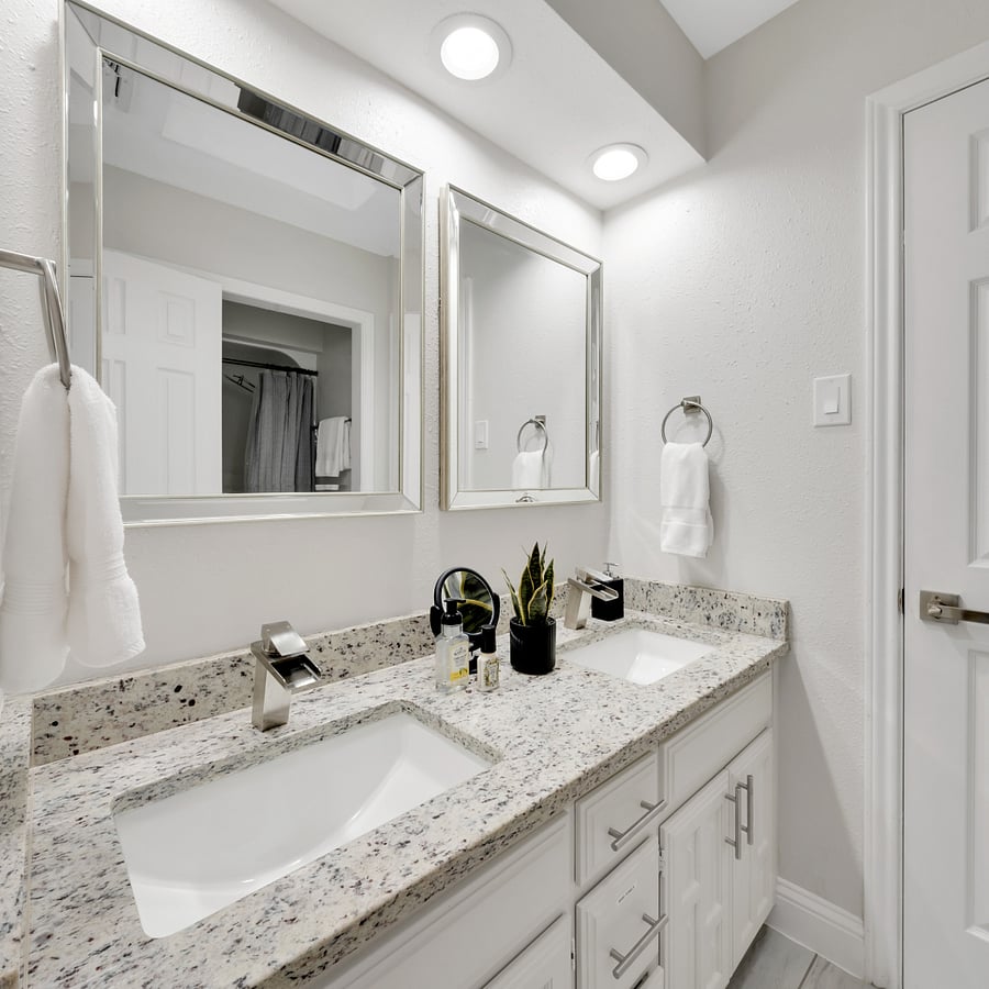 Jack-and-Jill Bathroom: Convenient shared bathroom with a tub and shower combination between two bedrooms.