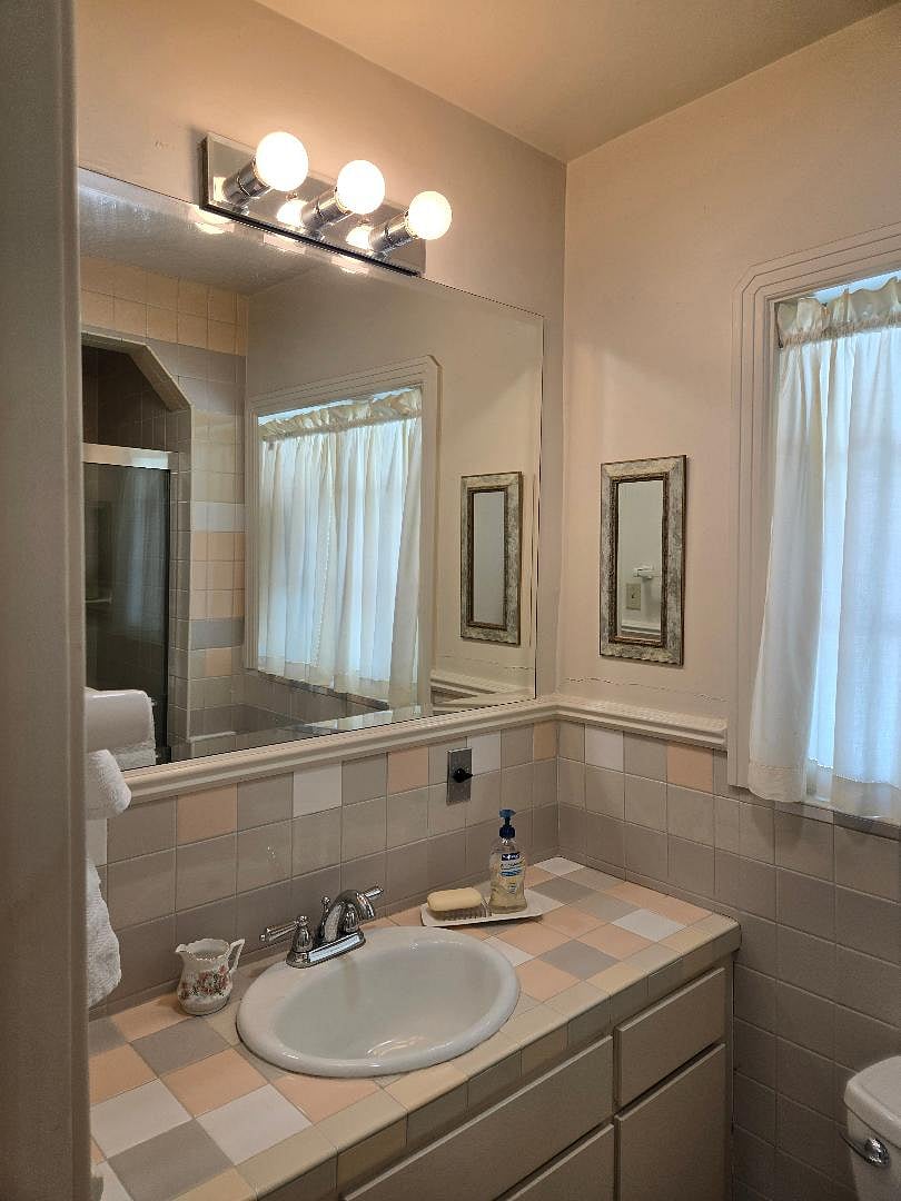 Semi-private bathroom with mirror and excellent lighting