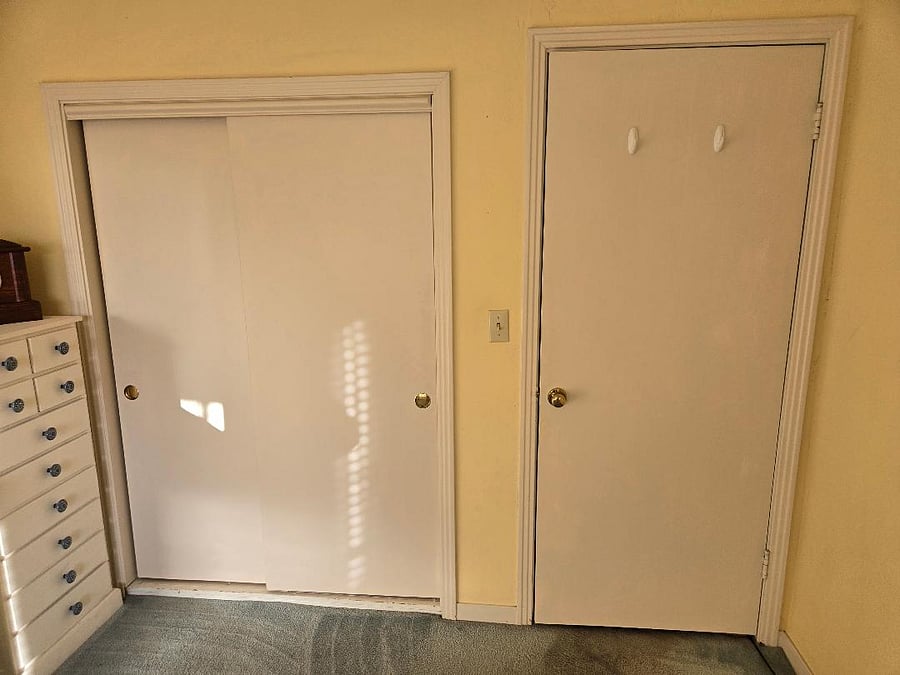 Inside bedroom perspective: closed closet door, closed bedroom door