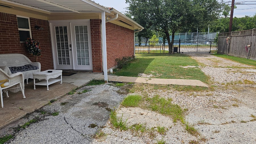Access door with keypad and driveway. View of tennis court park across the street.