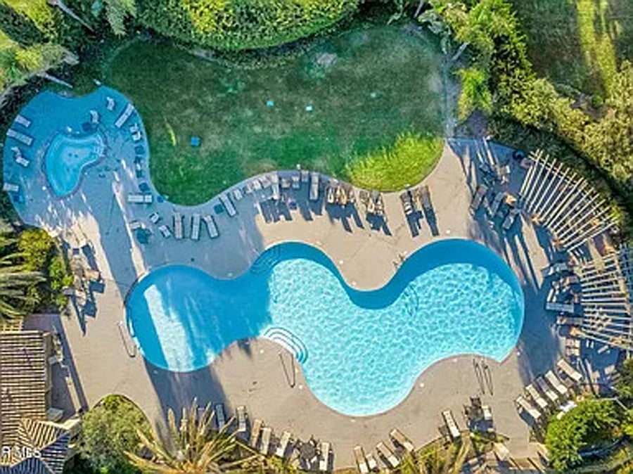 Clubhouse main freeform pool with jacuzzi.  Exercise room is at this location