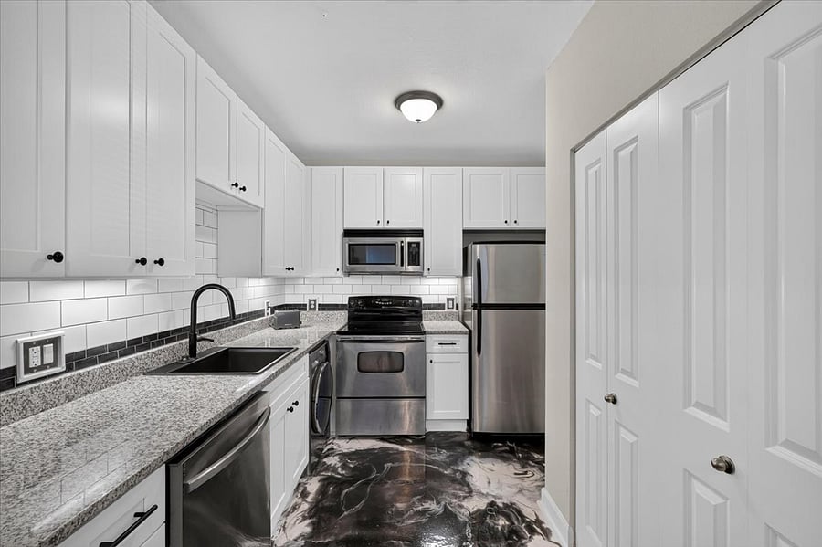 Renovated kitchen with unique epoxy floors. 