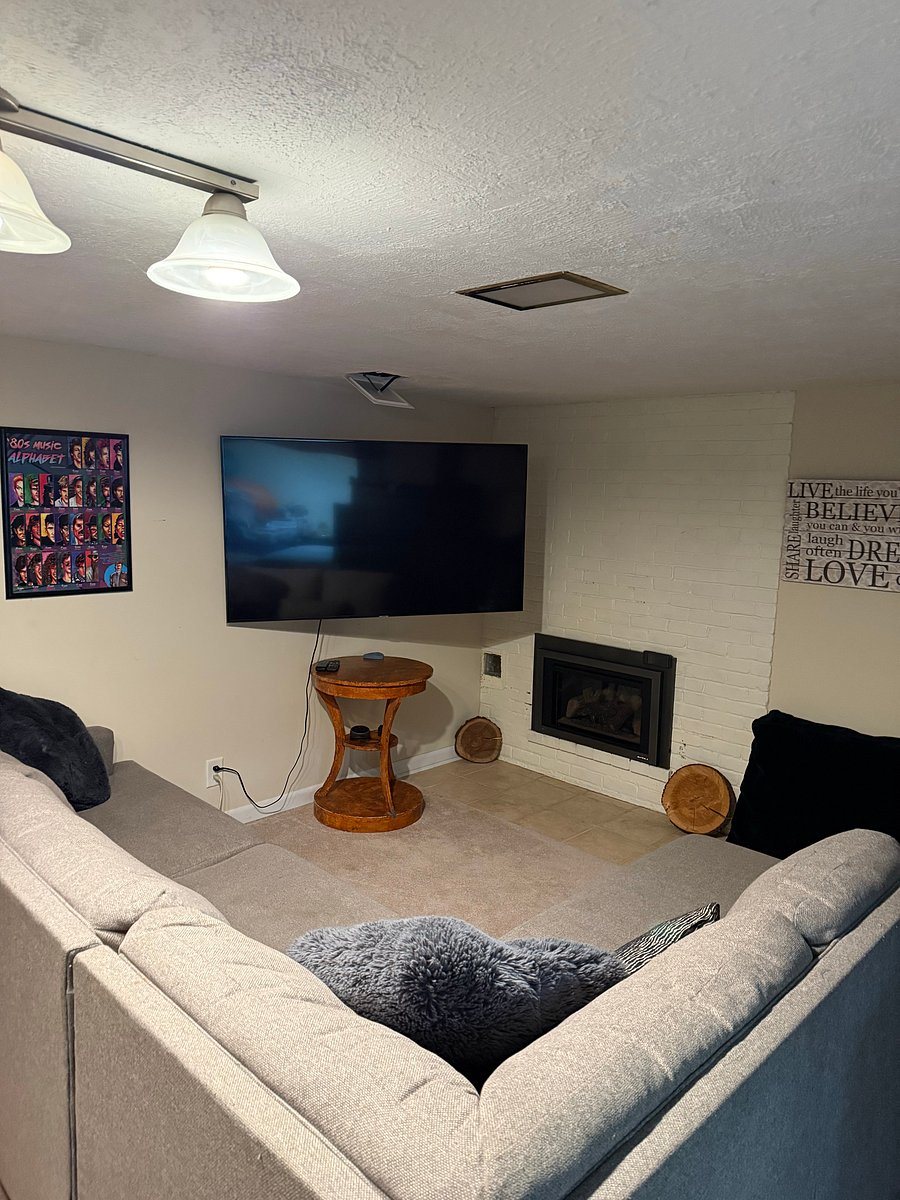Basement shared entertainment area with fireplace